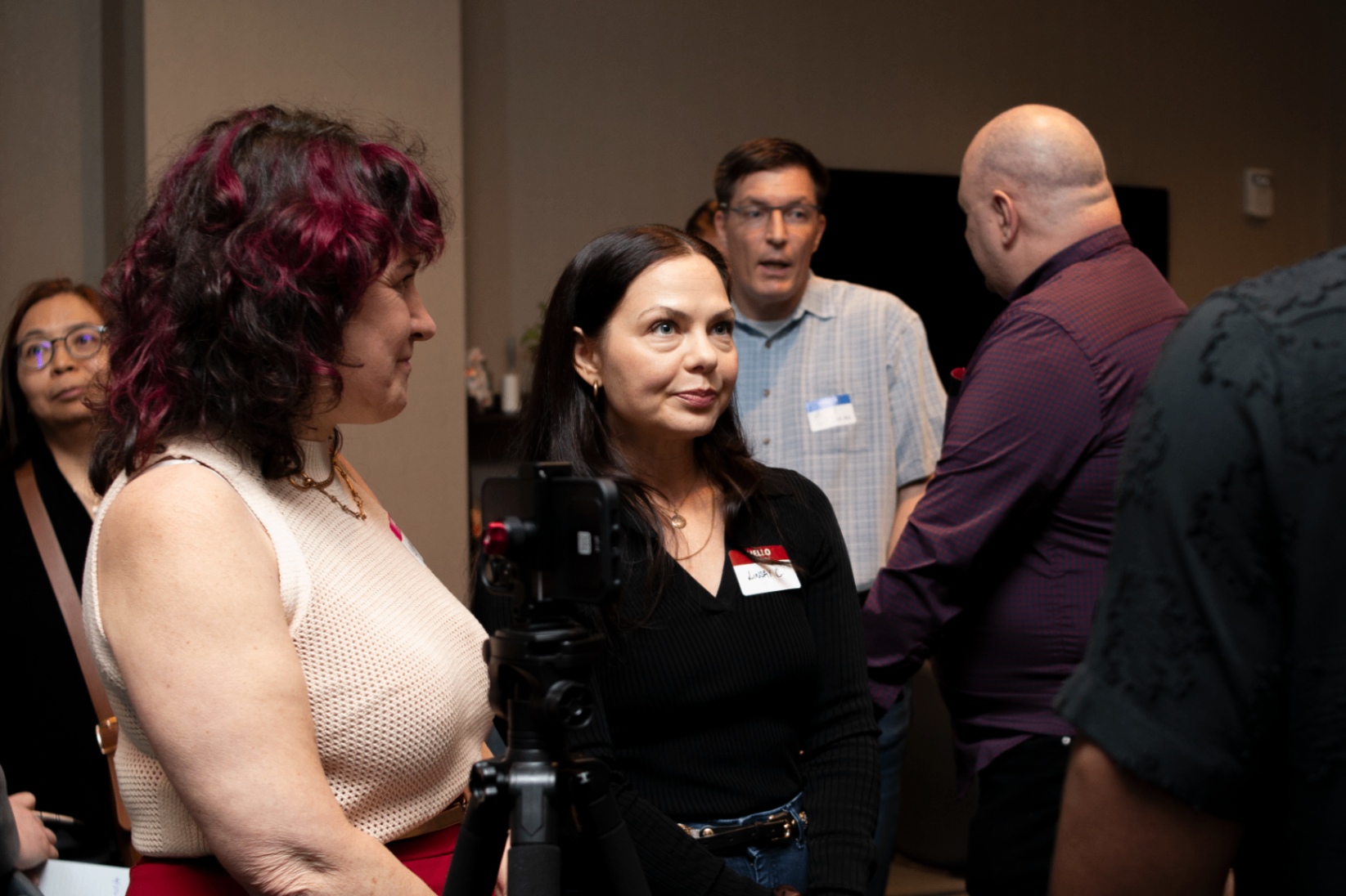 Small group gathering around a tripod during networking