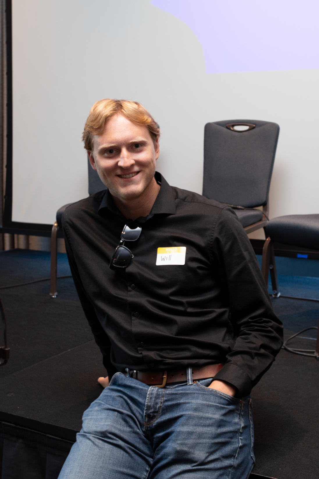 Portrait of an attendee seated near the stage