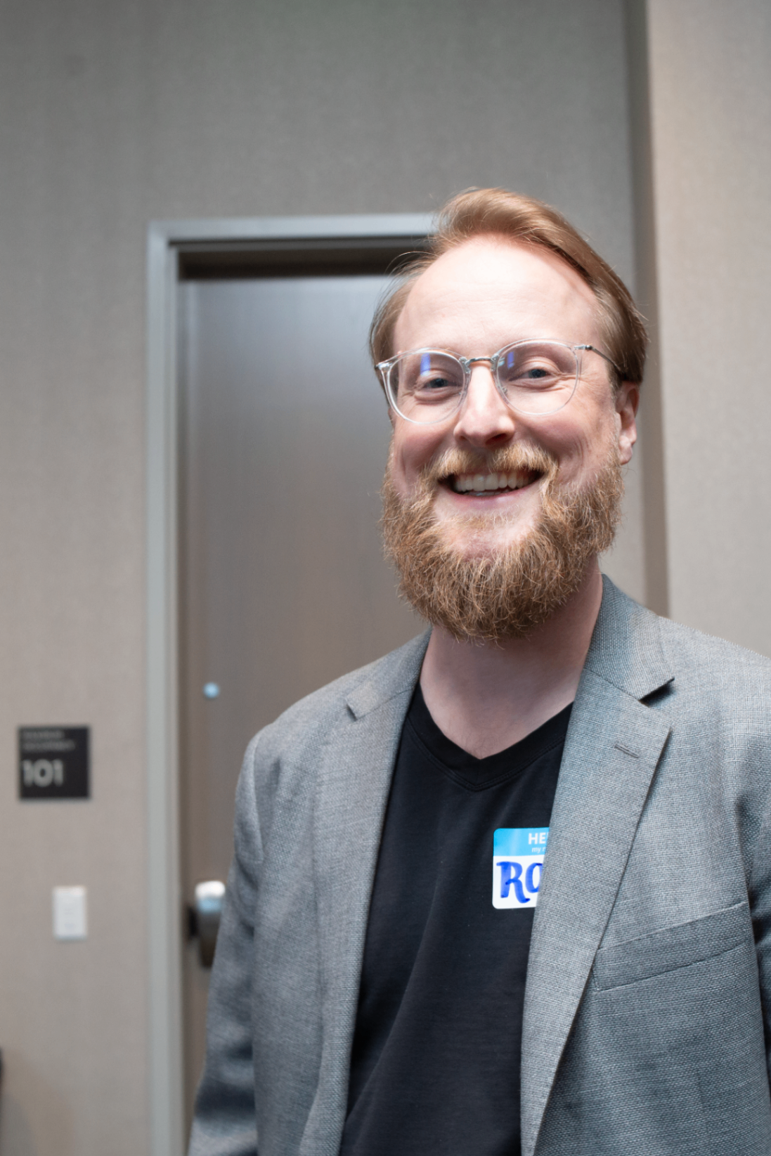 Portrait of an attendee wearing a blazer and name tag