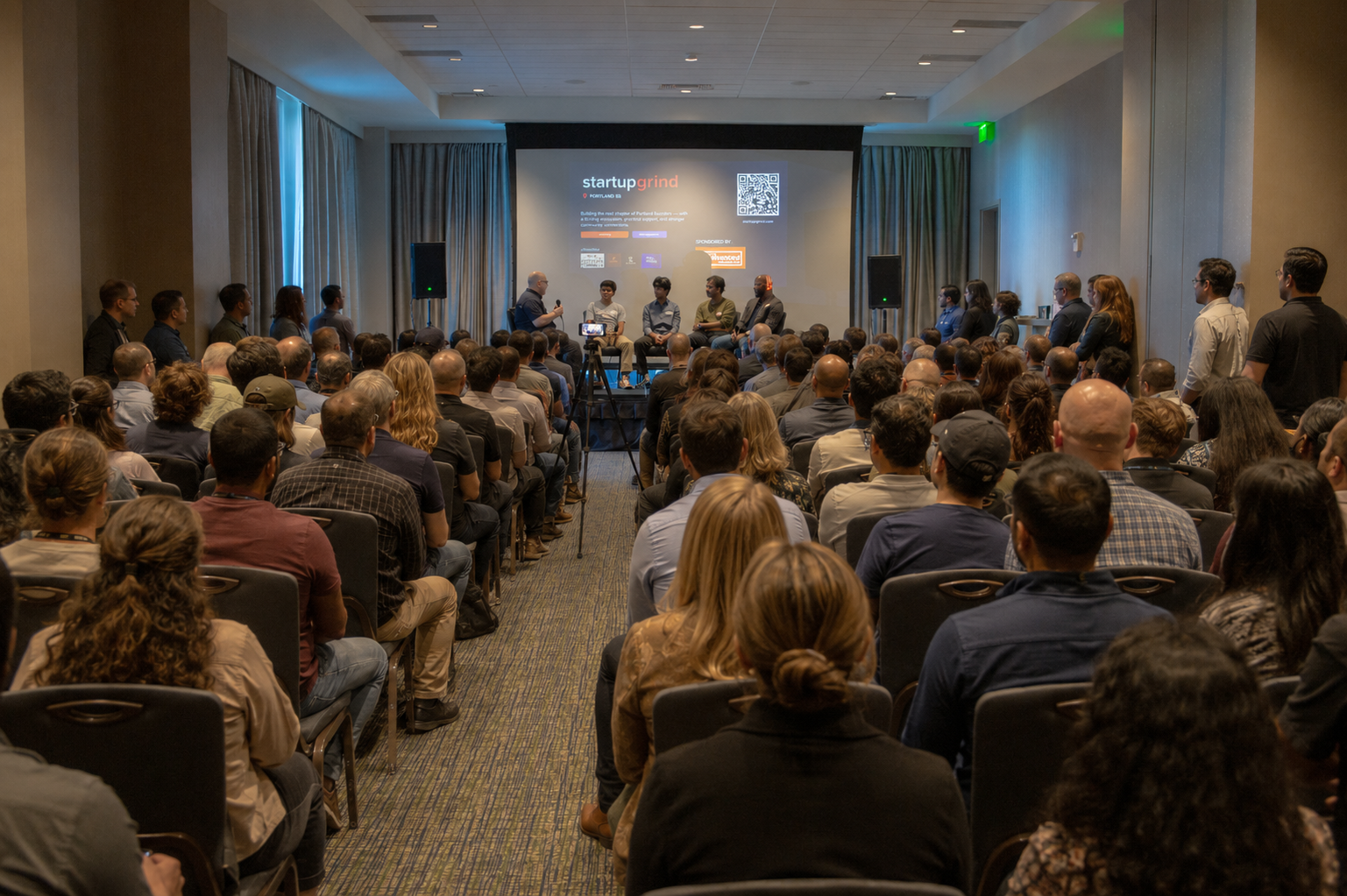 A packed Startup Grind Portland fireside chat with founders on stage
