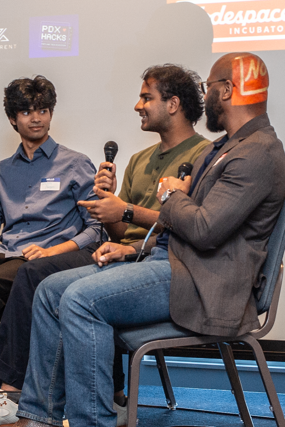 Panel speakers trading insights on stage during a fireside chat
