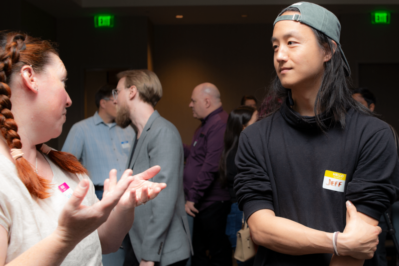 Attendees mid-conversation during a crowded networking moment