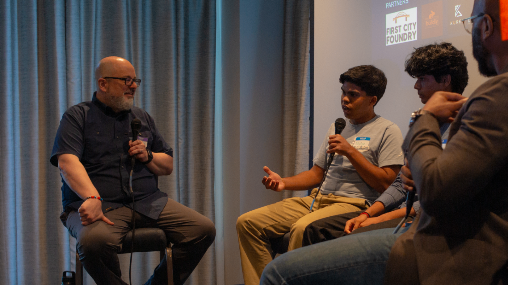 Panelists leaning into a discussion during the Startup Grind event