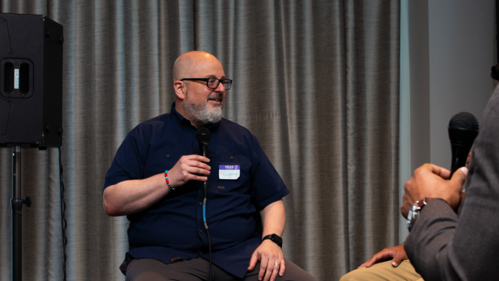 Moderator and founder in conversation on stage
