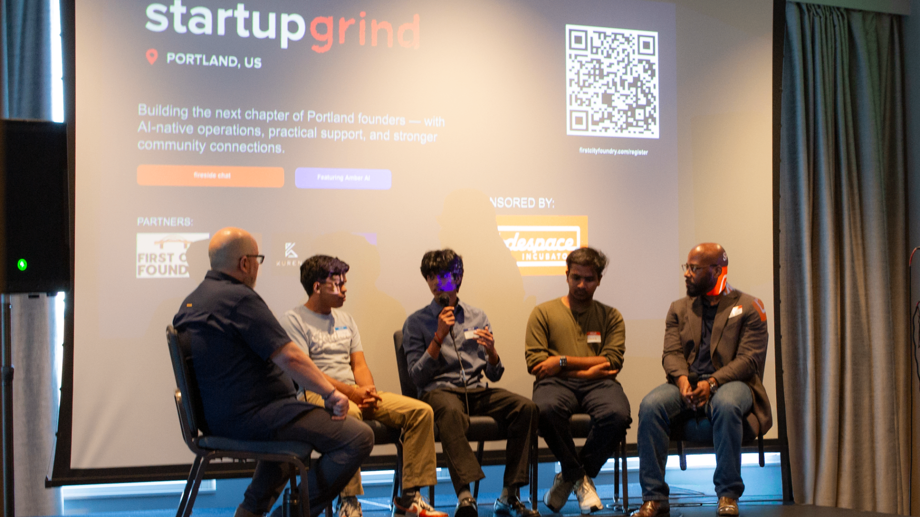Panel discussion in progress with founders seated on stage