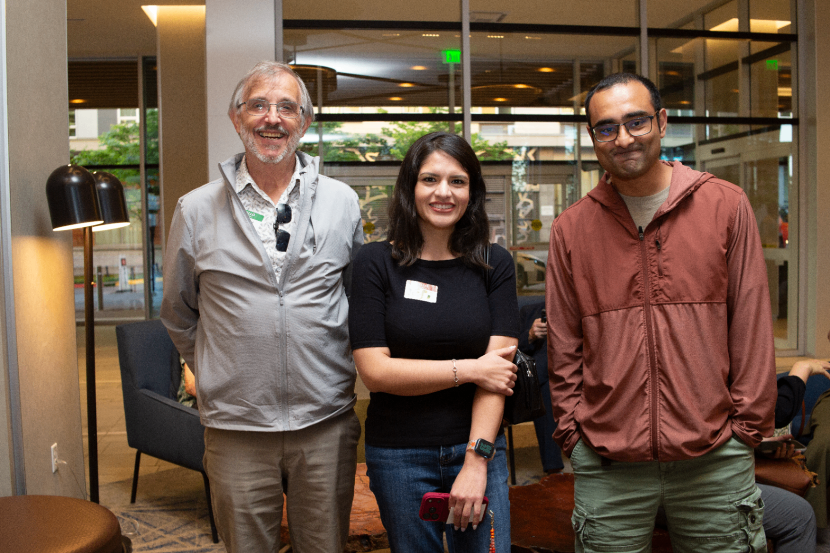 Three attendees posing for a chapter photo in the venue