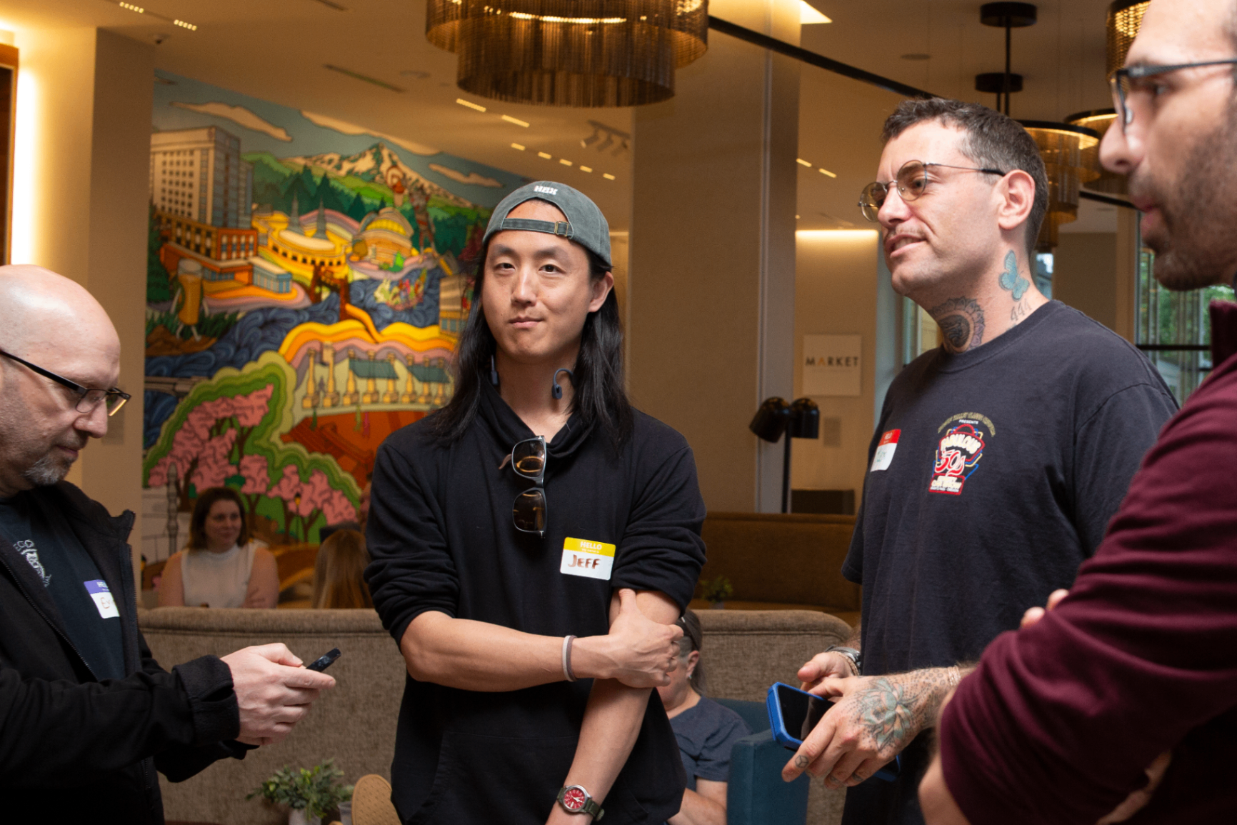 Founders talking in front of a colorful Portland mural